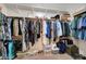 Walk-in closet with carpet and multiple shelves with clothes and accessories at 2779 Kindeace Ave, Henderson, NV 89044