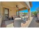 Comfortable covered patio with ample seating, ceiling fan, and views of the landscaped backyard at 2779 Kindeace Ave, Henderson, NV 89044