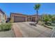 Spacious driveway with desert landscaping and a two-car garage for convenient parking at 2779 Kindeace Ave, Henderson, NV 89044
