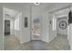 Inviting foyer featuring a decorative glass front door, shuttered windows, and neutral tile at 2779 Kindeace Ave, Henderson, NV 89044