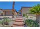 Inviting front of home with desert landscaping, neutral color scheme, and covered porch at 2779 Kindeace Ave, Henderson, NV 89044