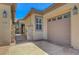 Close up view of a home's facade, showcasing neutral colors and two-car garage at 2779 Kindeace Ave, Henderson, NV 89044