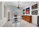 Bright home office with a modern desk, shuttered windows, stylish lighting, and elegant decorative touches at 2779 Kindeace Ave, Henderson, NV 89044