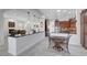 Open kitchen design with dark wood cabinets, a breakfast bar, stainless steel appliances, and modern lighting at 2779 Kindeace Ave, Henderson, NV 89044