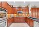 Modern kitchen featuring stainless steel appliances, dark wood cabinetry, tile backsplash, and sleek countertops at 2779 Kindeace Ave, Henderson, NV 89044