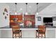 Open floor plan with a kitchen featuring wood cabinets, black countertops, and a seamless transition to the living area at 2779 Kindeace Ave, Henderson, NV 89044