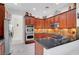 Beautiful kitchen boasting stainless steel appliances, wood cabinetry, modern lighting, and an elegant backsplash at 2779 Kindeace Ave, Henderson, NV 89044