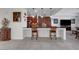 Kitchen bar seating area features granite counters and dark wood cabinetry at 2779 Kindeace Ave, Henderson, NV 89044