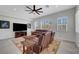 Bright living room offers plantation shutters, ceiling fan and leather furniture at 2779 Kindeace Ave, Henderson, NV 89044