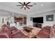 Open concept living room with ceiling fan, leather furniture, and bar seating at 2779 Kindeace Ave, Henderson, NV 89044