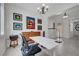 Home office featuring a modern desk, art collection, stylish chandelier and neutral tile flooring at 2779 Kindeace Ave, Henderson, NV 89044