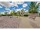 Scenic park view with walking paths, landscaping, mature trees, and inviting benches for relaxing outdoors at 2779 Kindeace Ave, Henderson, NV 89044