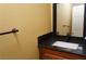 Bathroom with wood cabinets, granite counters, rectangular sink, and bronze faucet at 2851 S Valley View Blvd # 1134, Las Vegas, NV 89102