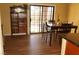 Dining room with hardwood floors, dark-wood table, chairs, and sliding glass door to backyard at 2851 S Valley View Blvd # 1134, Las Vegas, NV 89102