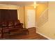 Bright living room with wood floors, a comfortable sofa, and stairs at 2851 S Valley View Blvd # 1134, Las Vegas, NV 89102