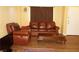 Comfortable living room with wood floors, a leather sofa, and a wooden coffee table at 2851 S Valley View Blvd # 1134, Las Vegas, NV 89102