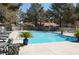 Community swimming pool with lounge chairs and tables, surrounded by lush greenery at 2851 S Valley View Blvd # 1134, Las Vegas, NV 89102
