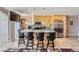 Modern kitchen features a granite countertop island with seating, stainless steel appliances, and stylish pendant lighting at 3111 Bel Air Dr # 201, Las Vegas, NV 89109