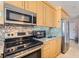 Close up of kitchen features stainless steel appliances, granite countertops, and light wood cabinetry at 3111 Bel Air Dr # 201, Las Vegas, NV 89109