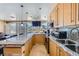 Kitchen features a granite countertop island with seating and stainless steel appliances at 3111 Bel Air Dr # 201, Las Vegas, NV 89109