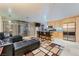 Open-concept living space with kitchen island seating and sliding glass doors to the balcony at 3111 Bel Air Dr # 201, Las Vegas, NV 89109
