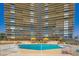 Inviting swimming pool with crystal-clear water, surrounded by lounge chairs and yellow canopies for a resort-style experience at 3111 Bel Air Dr # 201, Las Vegas, NV 89109