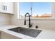 Kitchen sink with modern fixtures, quartz countertops, and a bright window at 313 Agora Way, Las Vegas, NV 89110
