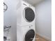 This laundry area features a stackable washer and dryer at 313 Agora Way, Las Vegas, NV 89110
