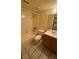 Well-lit bathroom with tiled floor, a bathtub and shower combo, a toilet, and a vanity sink, offering essential amenities at 3412 Mercury St # I, North Las Vegas, NV 89030
