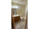 Clean bathroom with tiled floors, a shower-tub combo, toilet, and a wood vanity, combining comfort and functionality at 3412 Mercury St # I, North Las Vegas, NV 89030
