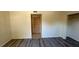 Well-lit bedroom features modern vinyl flooring, closet, and a window with security bars offering a comfortable living space at 3412 Mercury St # I, North Las Vegas, NV 89030