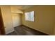 This bedroom features wood floors, a built-in closet, and a window for natural light at 3412 Mercury St # I, North Las Vegas, NV 89030