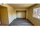 Spacious bedroom features modern vinyl flooring, closet, and a window with security bars offering a comfortable living space at 3412 Mercury St # I, North Las Vegas, NV 89030