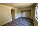 Inviting bedroom features modern vinyl flooring, closet, and a window with security bars offering a comfortable living space at 3412 Mercury St # I, North Las Vegas, NV 89030