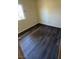 This bedroom boasts wood-look flooring, a window with security bars, and ample natural light, creating a comfortable and safe retreat at 3412 Mercury St # I, North Las Vegas, NV 89030