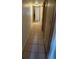 Long hallway with tile flooring leading to additional rooms with convenient access to storage at 3412 Mercury St # I, North Las Vegas, NV 89030