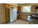 Bright kitchen with stainless steel appliances, granite countertops, tile flooring, and wood cabinets at 3412 Mercury St # I, North Las Vegas, NV 89030