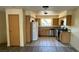 Bright kitchen features wood cabinets, stainless steel appliances, tile floors, and a window with a view at 3412 Mercury St # I, North Las Vegas, NV 89030