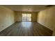 Living room with sliding glass doors leading to outdoor space and new flooring throughout at 3412 Mercury St # I, North Las Vegas, NV 89030