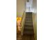 Carpeted stairs with wooden handrail leading to the upper level of a bright home at 3412 Mercury St # I, North Las Vegas, NV 89030