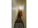 View down carpeted stairs leading to a warmly lit entry door of a cozy home at 3412 Mercury St # I, North Las Vegas, NV 89030