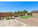 Landscaped backyard featuring decorative turf, gravel, and shrubbery at 3609 Kingfishers Catch Ave, North Las Vegas, NV 89084