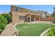 Expansive backyard showcases a well-kept artificial lawn, desert landscaping, and a covered patio at 3609 Kingfishers Catch Ave, North Las Vegas, NV 89084