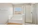 Primary bath features a soaking tub, separate shower, and large window at 3609 Kingfishers Catch Ave, North Las Vegas, NV 89084