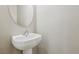 Small bathroom with a pedestal sink and oval mirror at 3609 Kingfishers Catch Ave, North Las Vegas, NV 89084