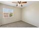 Neutral bedroom featuring a ceiling fan, large window, and wall-to-wall carpeting at 3609 Kingfishers Catch Ave, North Las Vegas, NV 89084
