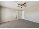 Bedroom with neutral carpeting, ceiling fan, and ensuite bath at 3609 Kingfishers Catch Ave, North Las Vegas, NV 89084