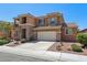 Two-story home featuring stone accents, a two-car garage, and well-maintained landscaping at 3609 Kingfishers Catch Ave, North Las Vegas, NV 89084