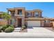 Inviting two-story home featuring stone accents, a two-car garage, and lush landscaping for curb appeal at 3609 Kingfishers Catch Ave, North Las Vegas, NV 89084
