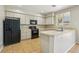 Kitchen featuring neutral cabinets, black appliances, and tile countertops at 3609 Kingfishers Catch Ave, North Las Vegas, NV 89084
